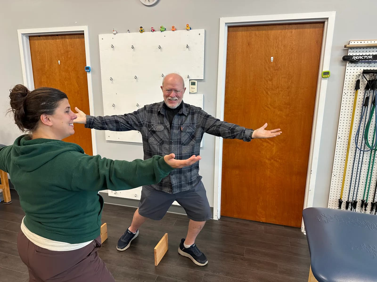Guided stepping exercise with arms extended in a Fusion clinic.